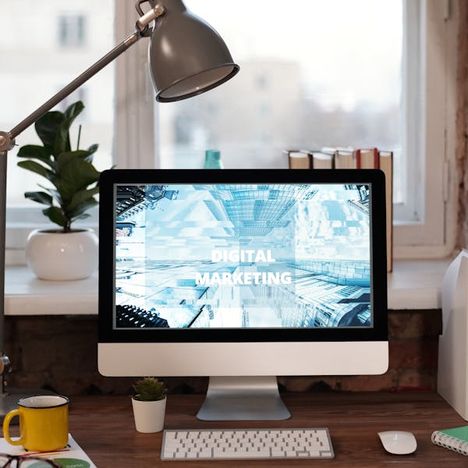 Contemporary desk setup with a large display and natural light